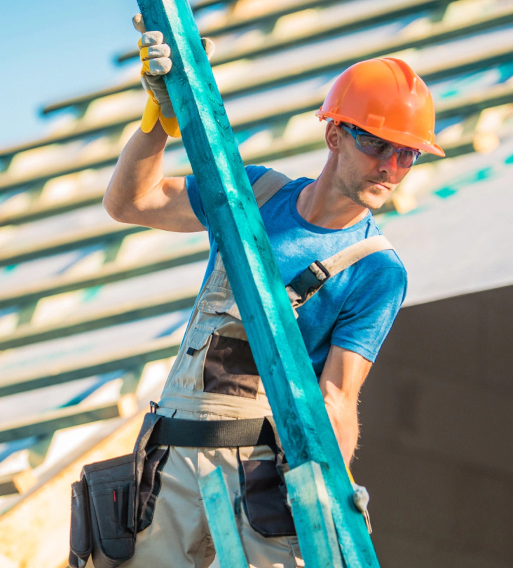 man doing roofing work holding wood for repair fairview AL
