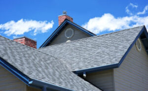 closeup view of a gray shingle roof on a large, suburban home